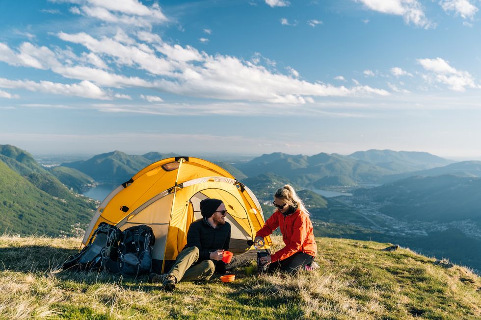 1649776480409058675.jpg couple-camping-on-mountain-top-prepare-food-and-royalty-free-image-1645543122.jpg